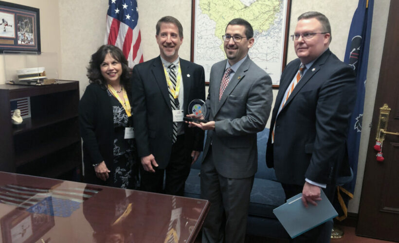 Member Outreach Manager Lena Hannah PSBA President David Hein and PSBA CEO Nathan Mains present Rep. Ortitay with PSBA Champion of Eudcation award