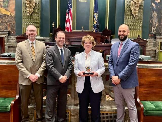 Andrew Christ, John Callahan and Jonathan Berger present Senator Brooks with Champion of Public Education award