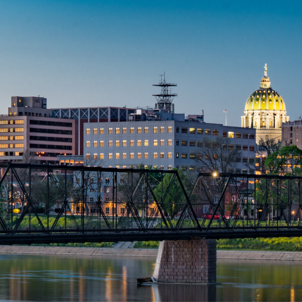 Harrisburg cityscape with illuminated capital building.